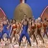 1988 Crystal Light National Aerobic Championship — Wide shot of the ensemble performance showing multiple performers in various colored aerobic attire in