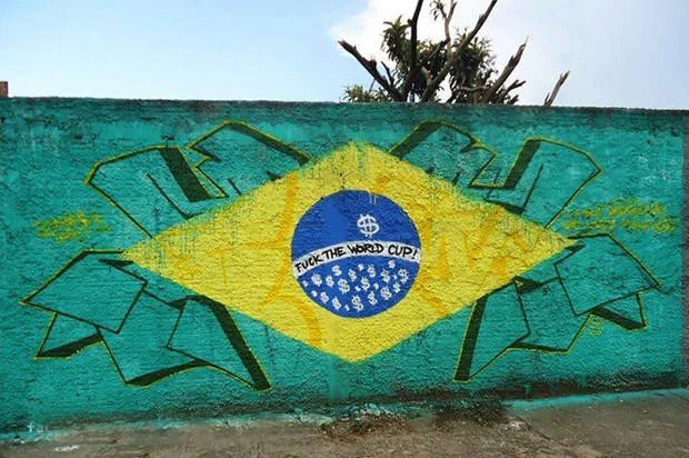 2014 Fifa World Cup Brazil — Anti-World Cup graffiti on Brazilian flag with 'Fuck the World Cup' text
