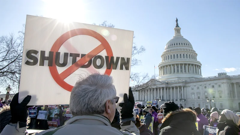 2018 2019 United States Government Shutdown — Protester holds anti-shutdown sign in front of the U.S. Capitol dome