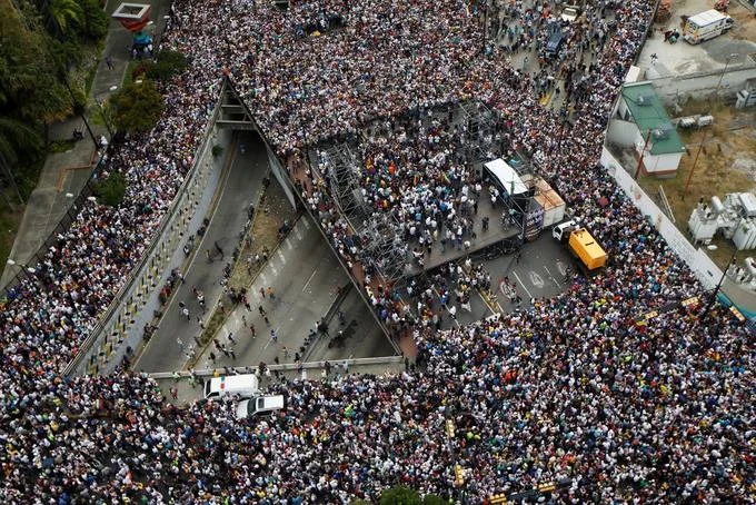 2019 Venezuelan Presidential Crisis — Aerial view of massive protest crowd filling Caracas streets