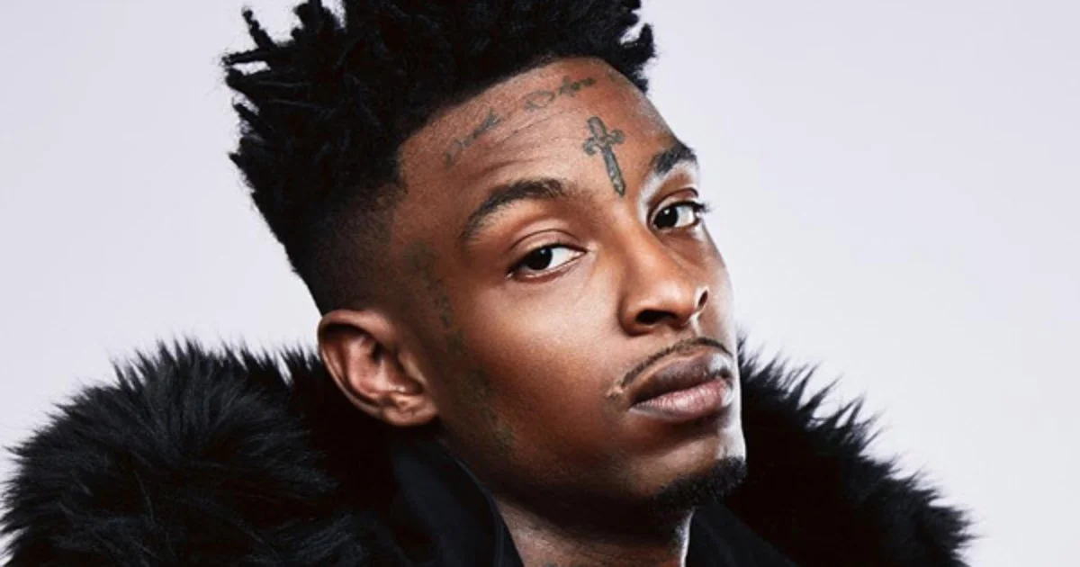 Portrait of rapper 21 Savage with face tattoos wearing a fur-lined jacket