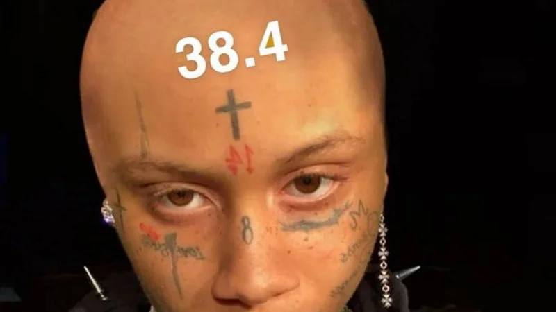 384 — Primary image showing '38.4' overlaid on person's forehead with visible tattoos, no social media handles.