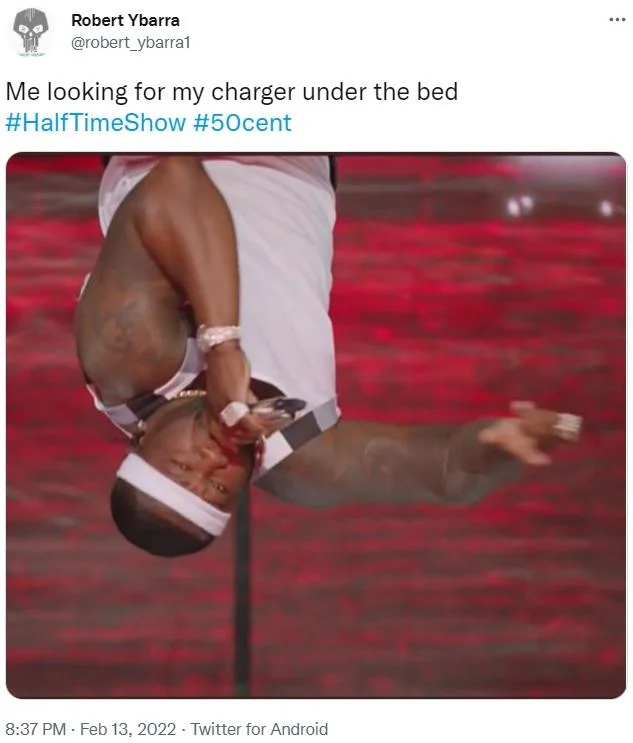 50 Cent Hanging Upside Down — Person in red and white outfit hanging upside down with bed search caption.