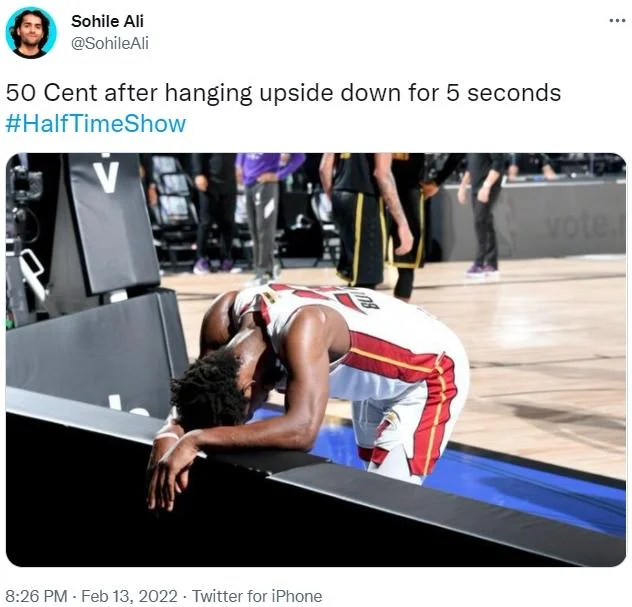 50 Cent Hanging Upside Down — Person lying on stage platform with caption about 50 Cent after 5 seconds upside down.