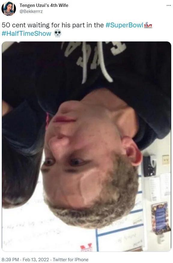 50 Cent Hanging Upside Down — Inverted photograph with caption about 50 Cent waiting during halftime show.