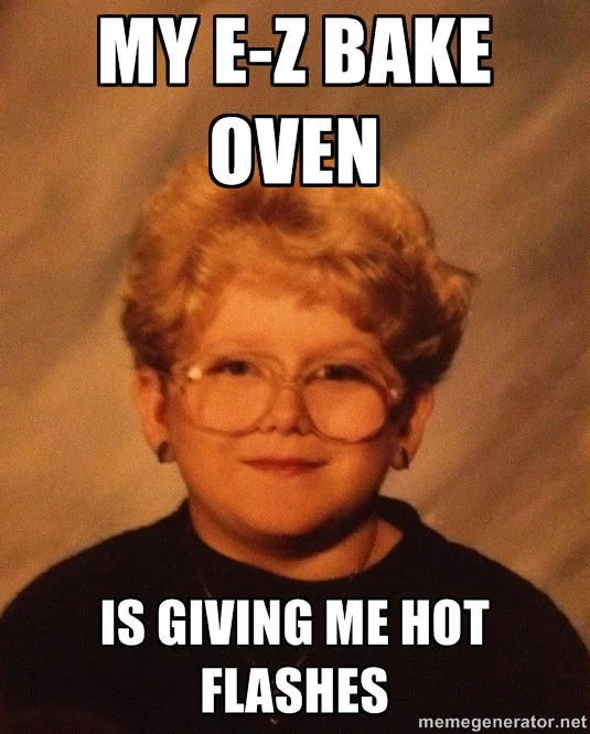 The 60 Year Old Girl meme with text 'MY E-Z BAKE OVEN / IS GIVING ME HOT FLASHES', combining children's toys with elderly woman experiences.