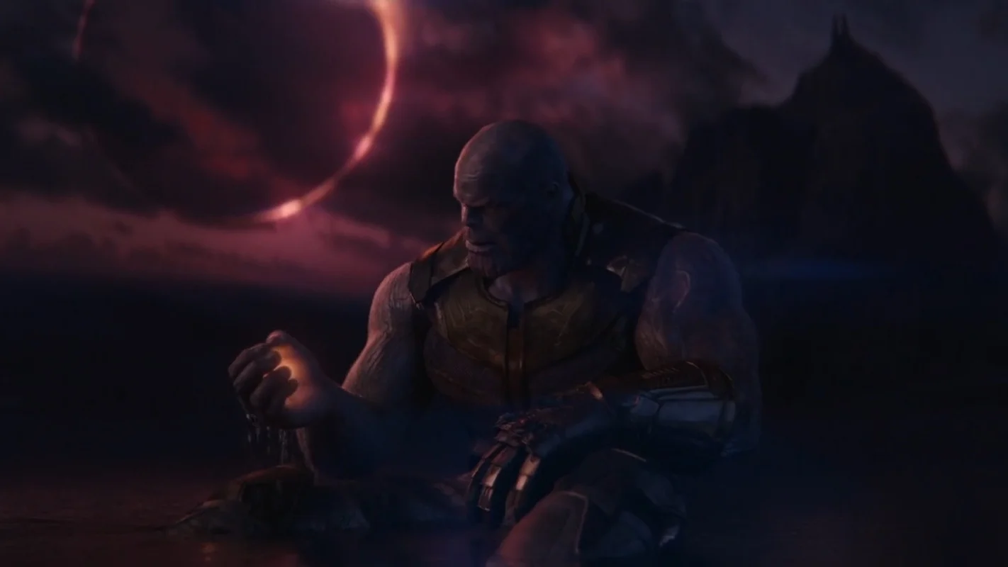 A Soul For A Soul — Thanos sitting on Vormir holding the glowing Soul Stone with eclipsed sun in background