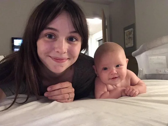 Acacia And Baby Photo Men Only Want One Thing — Young mother and baby lying together on a white bed