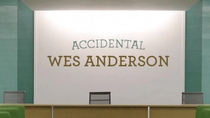 Symmetrical conference room with 'Accidental Wes Anderson' text on wall