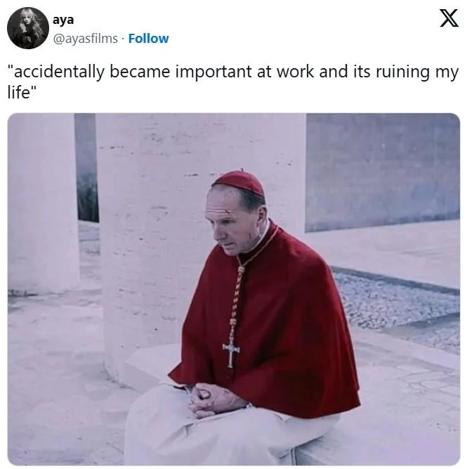 Ralph Fiennes as a cardinal sitting dejectedly on steps with 'accidentally became important at work' caption