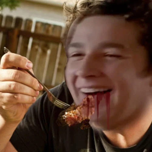 Actual Cannibal Shia Labeouf — Shia LaBeouf smiling while eating bloody meat off a fork outdoors