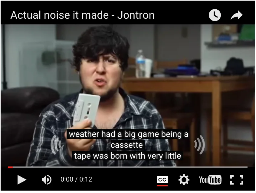 YouTube player screenshot of JonTron holding a cassette tape, with the video titled 'Actual noise it made - Jontron' and auto-generated captions displayed.