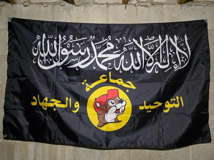 Al Buqqi — Physical al-Buqqi parody flag hanging on a concrete wall