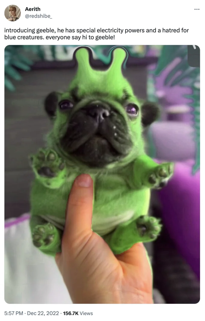 Alienposting Zeep Glorp — Green alien pug puppy with antennae ears held in a person's hand