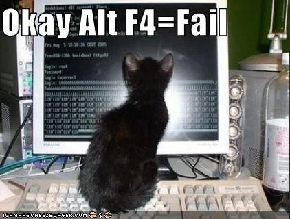 Black cat sitting at old computer with monitor displaying prompts captioned 'Okay Alt F4=Fail'.