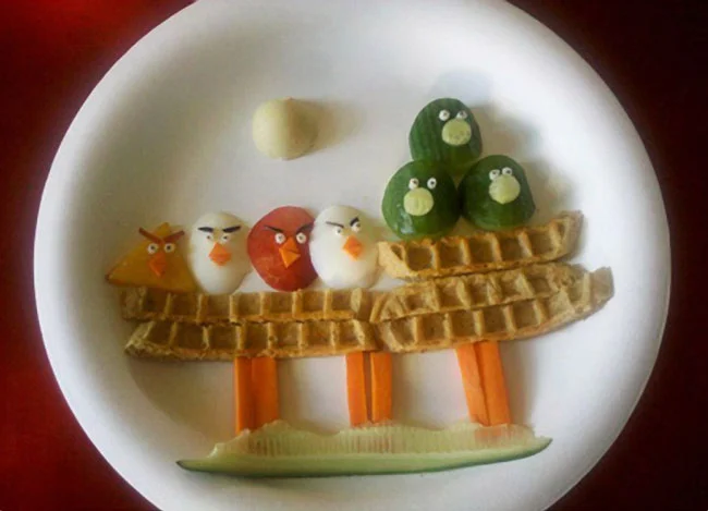 Angry Birds scene created from waffles, eggs and vegetables on a plate