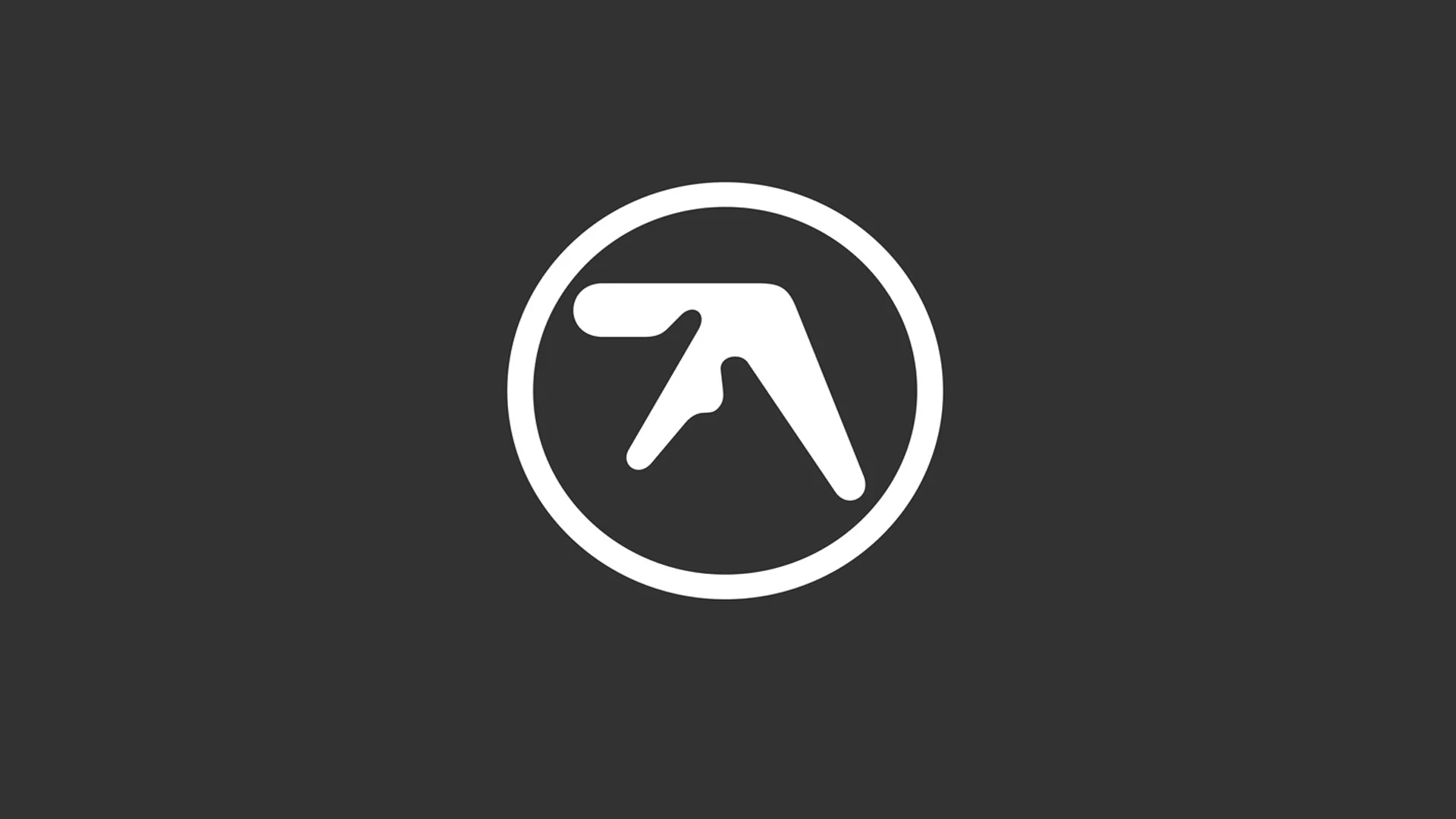 White Aphex Twin circular logo on a dark gray background