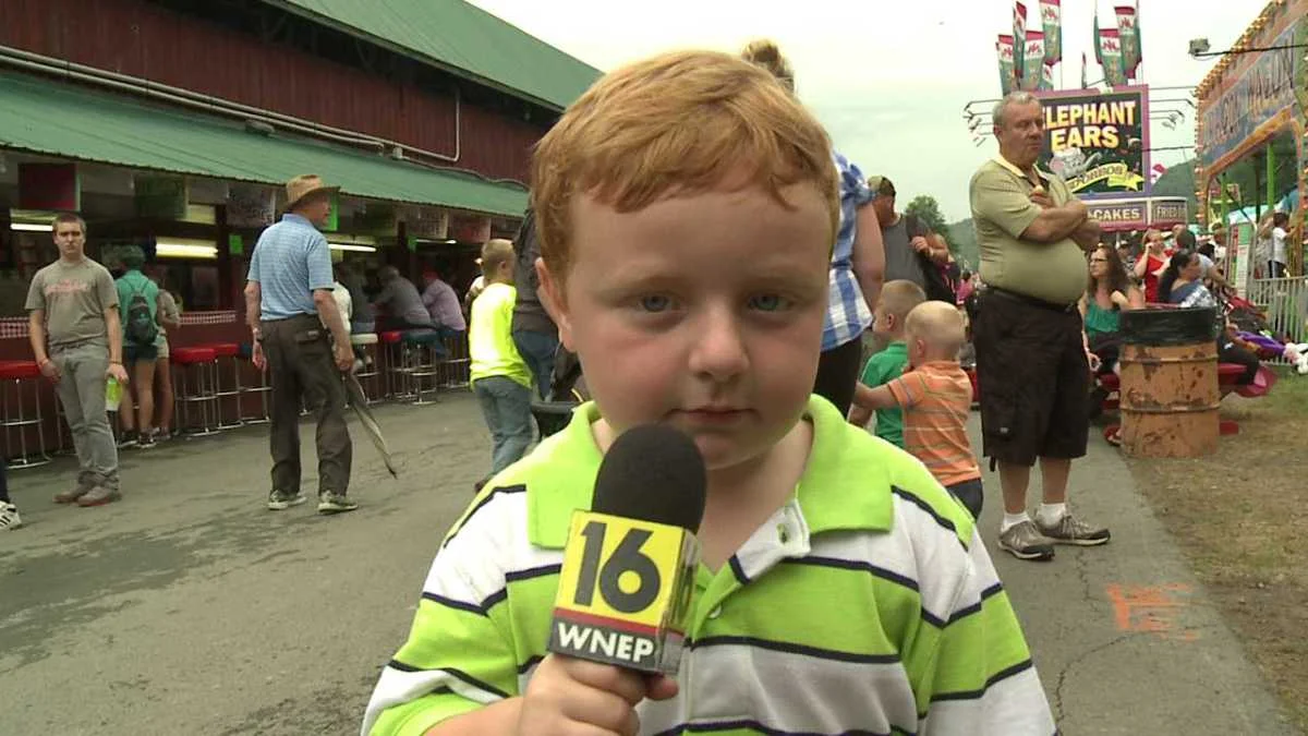 Apparently Kid — Red-haired boy Noah Ritter holding a WNEP 16 news microphone at the Wayne County Fair