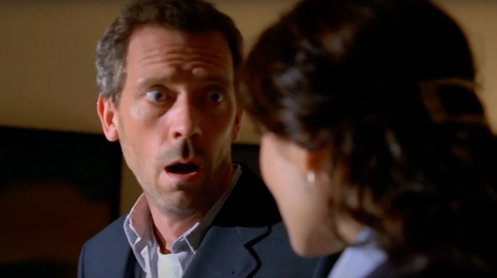 Are You Being Intentionally Dense? "Huh?" — Dr. Gregory House from House M.D. with a shocked, wide-eyed expression facing a woman with dark hair