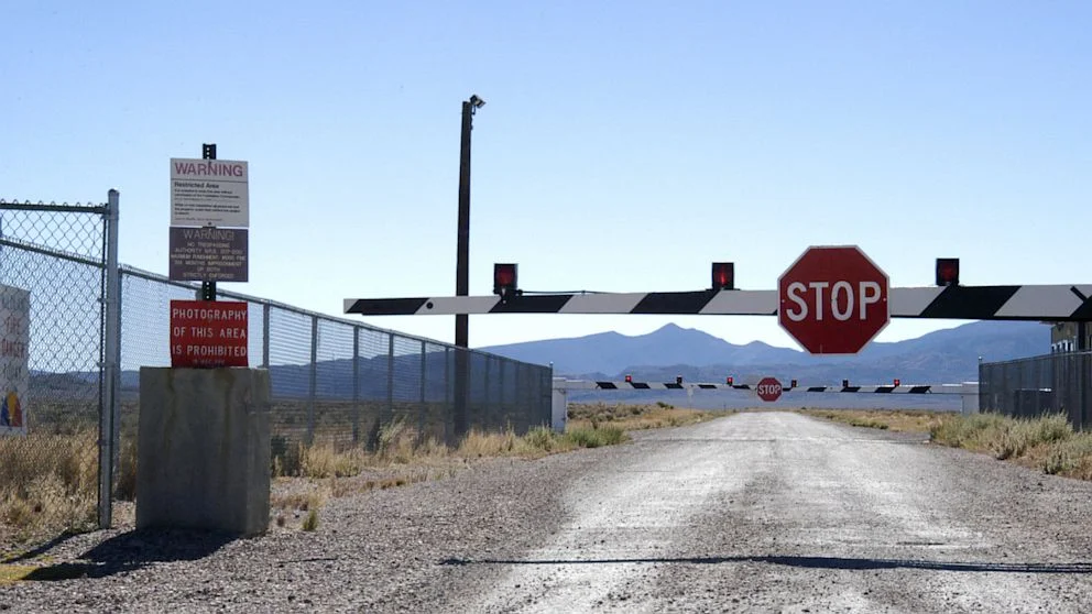 Area 51 Raid — Photograph of actual Area 51 entrance with warning signs and fencing.