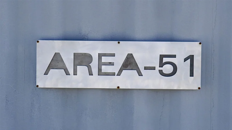 Area 51 — Metal sign reading AREA-51 mounted on a blue-gray wall