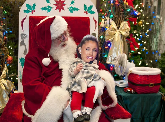 Young Ariana Grande crying on Santa's lap in a Christmas photo