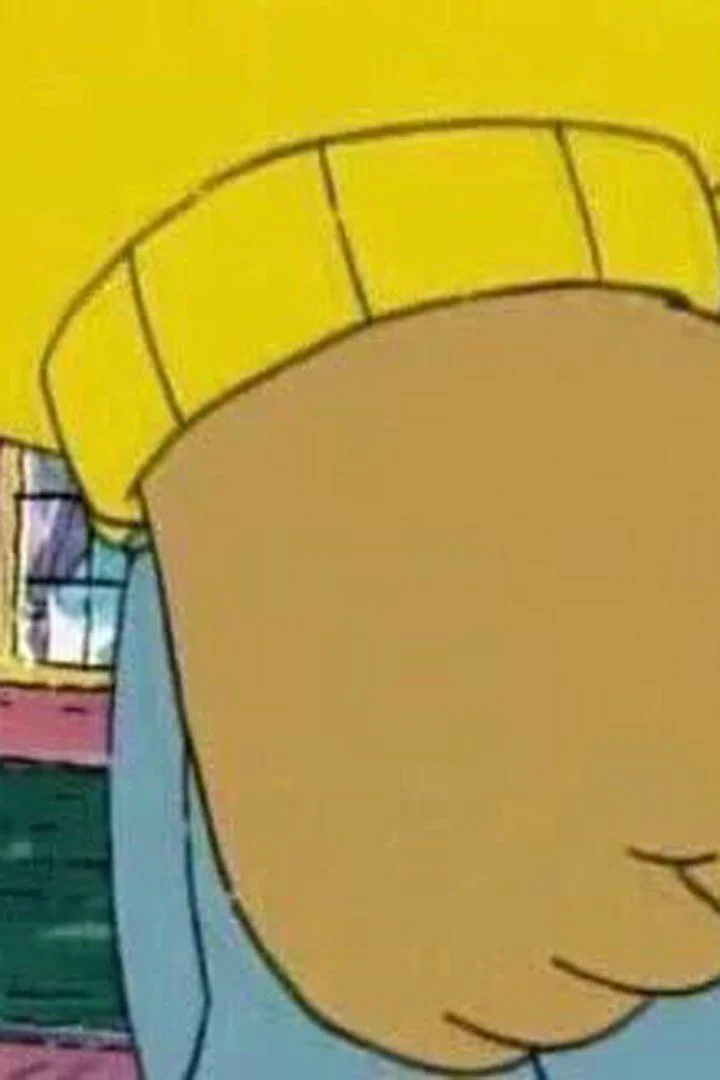Arthur's Fist — Clean cropped screenshot of Arthur Read's clenched fist in yellow sweater with cartoon street background.