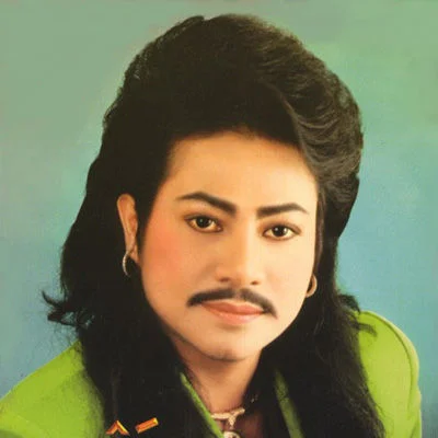 Asian Prince — Portrait of a young Asian man with a large mullet hairstyle and thin mustache wearing a green jacket