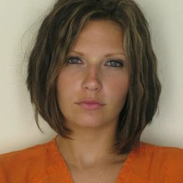 Original mugshot of Meagan Simmons, the Attractive Convict, in orange jumpsuit