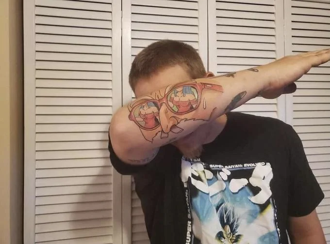 Awful Taste, But Great Execution — Man dabbing to show off a colorful anime forearm tattoo