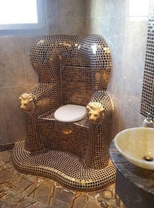 Awful Taste, But Great Execution — Mosaic-tiled throne-style toilet with lion-head armrests in a tiled bathroom