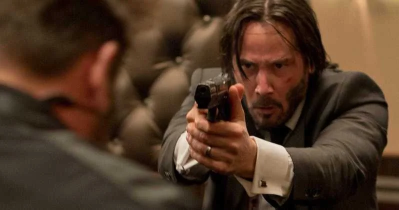 Bad Guys Vs John Wick — John Wick aiming a handgun at an enemy in a hotel scene