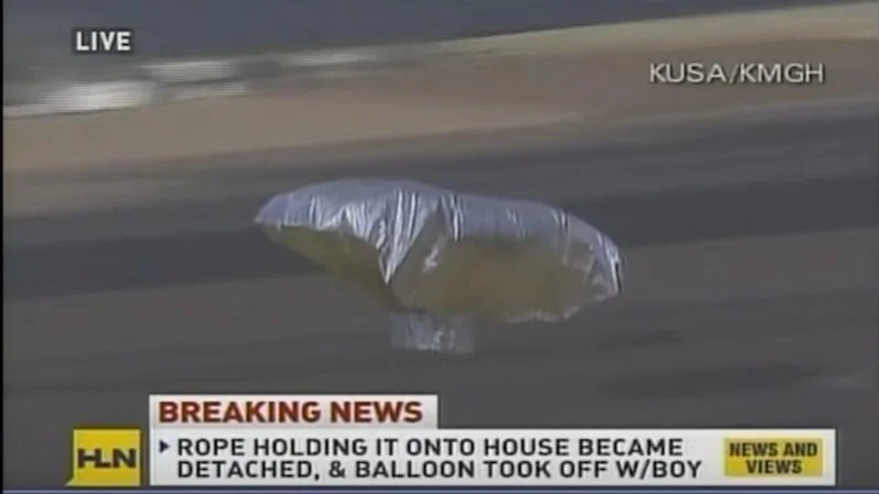 Live news broadcast of silver Mylar balloon ascending into sky during Balloon Boy hoax.