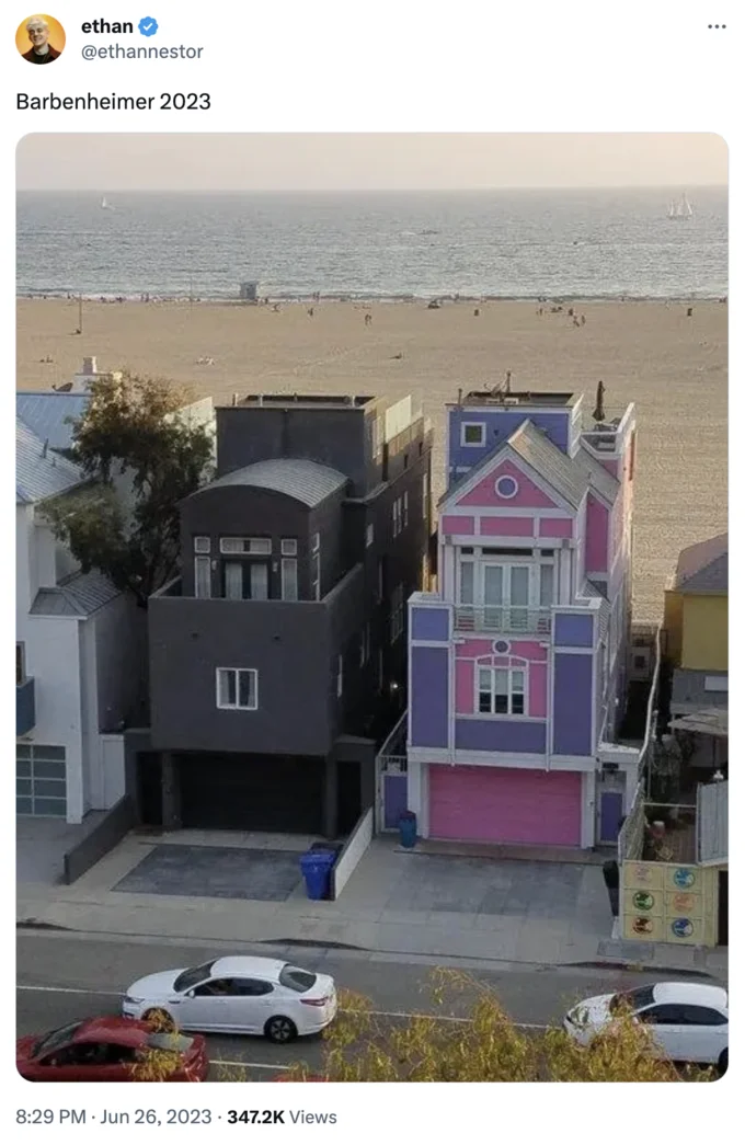 Barbenheimer — Art installation with dark industrial house and vibrant pink house contrasting aesthetics.