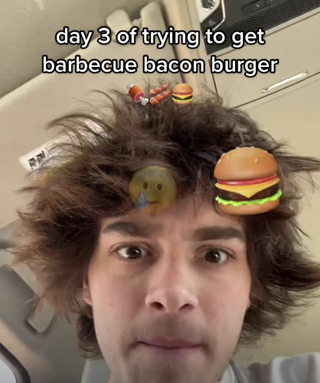 Barbeque Bacon Burger (TikTok Challenge) — Selfie of a tired young man with messy hair in a car with burger emoji and the caption 'day 3 of trying to get