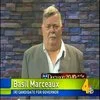 Basil Marceaux on local Nashville news broadcast in tan jacket with yellow chyron.