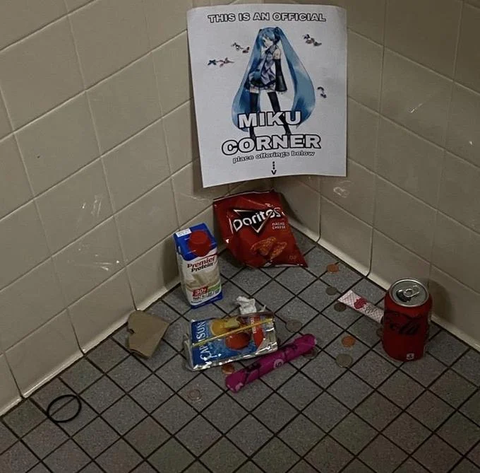 Bathroom Shrines — Bathroom shrine dedicated to Miku with 'OFFICIAL MIKU CORNER' sign.