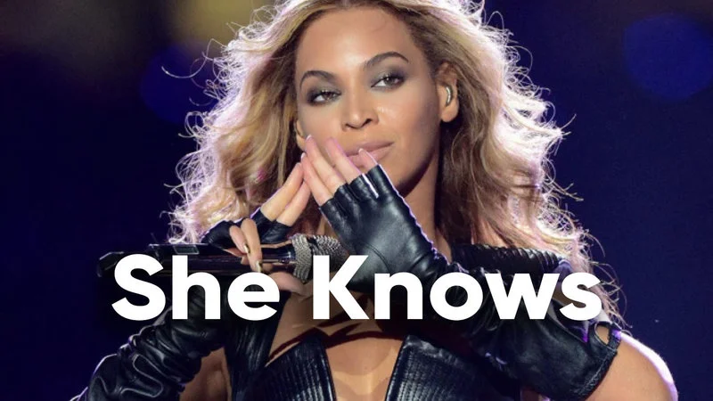 Beyonce She Knows Theories — Clean performance image of Beyoncé mid-performance with white text overlay reading 'She Knows,' referencing J. Cole's song.