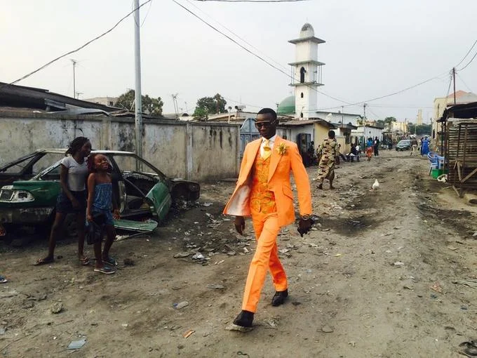 Black Guy In Orange Suit — Lower resolution image of the man in orange suit walking down a dirt road