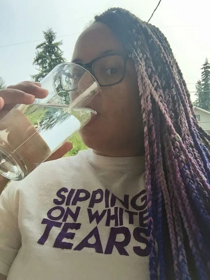 Black Lives Matter — Woman in Sipping on White Tears shirt drinking from a glass