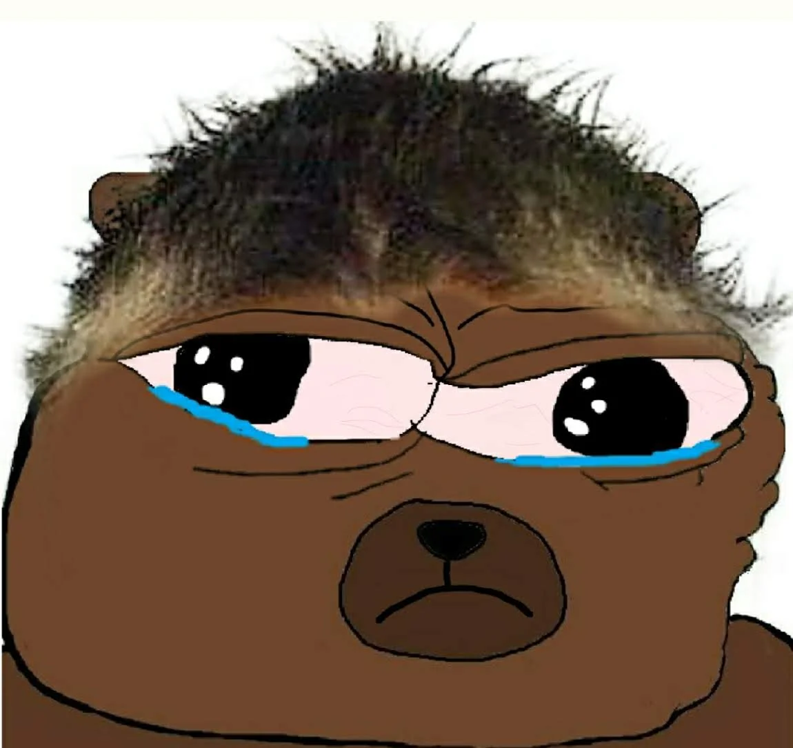 Close-up of Bobo The Bear with messy brown hair, teary eyes, furrowed brow, and a frowning mouth.