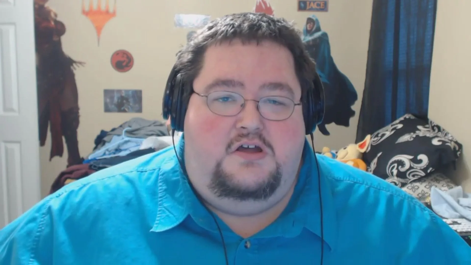 Boogie2988 in blue shirt with headphones during a webcam video