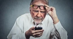 Boomer Confusion — A professional stock photo of an older man wearing glasses and white shirt with puzzled, bewildered expression and hand raised to glasses in