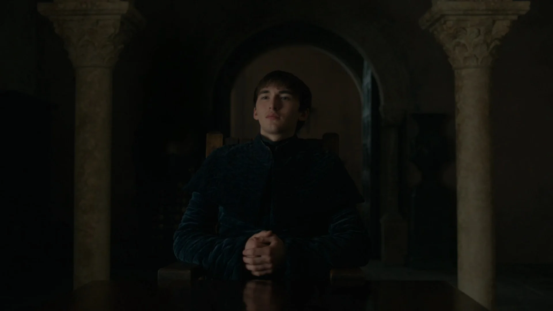 Bran The Broken — Bran Stark seated at a table in a dark hall from Game of Thrones
