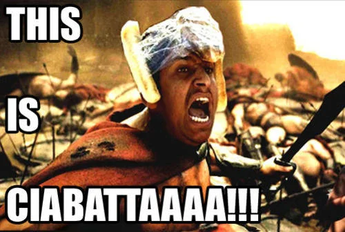 A Photoshop composite superimposing Bread Helmet Man's face onto Leonidas's body from 300, with battlefield backdrop and text 'THIS IS CIABATTAAAA!!!'