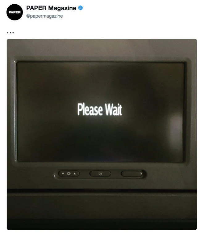 Break The Internet — A Twitter screenshot from Paper Magazine account showing a 'Please Wait' loading screen, implying their website crashed from overwhelming