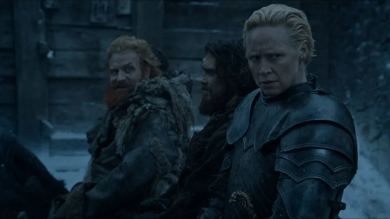 Brienne And Tormund — A wintry Game of Thrones scene still showing Tormund with red beard and wide grin in background, Brienne in full armor in foreground