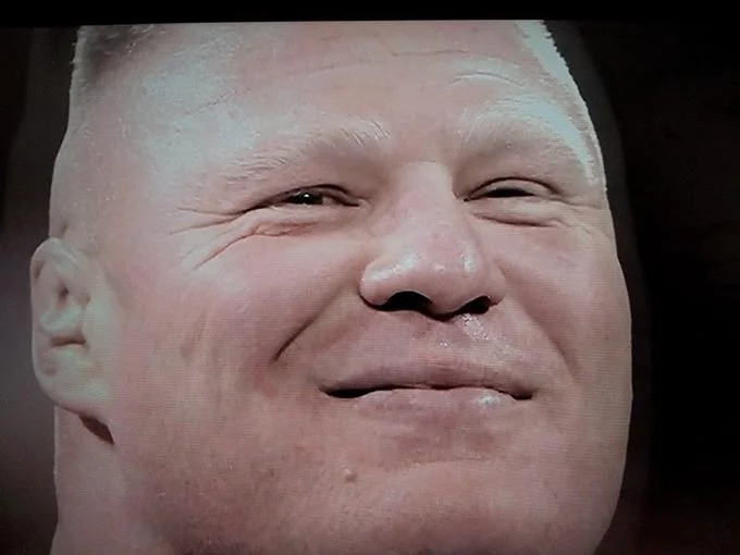 Brock Lesnar smirking in a close-up portrait