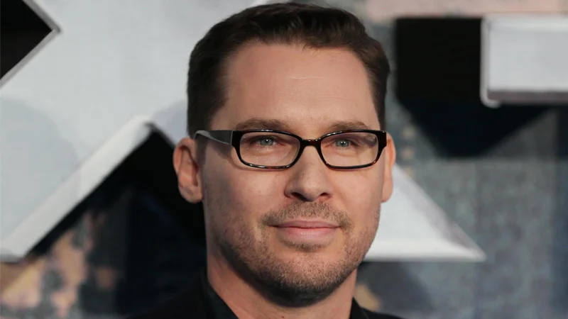 Bryan Singer Sexual Misconduct Allegations — Bryan Singer close-up portrait with glasses at a film premiere