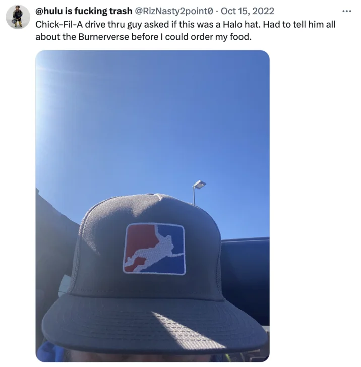 Tweet showing a cap with a burnerverse logo and a story about explaining it at a Chick-Fil-A drive-thru.